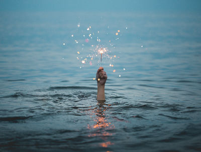 Image of hand holding sparkler